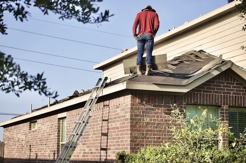Professional roofer working on a residential roof in Kiesel